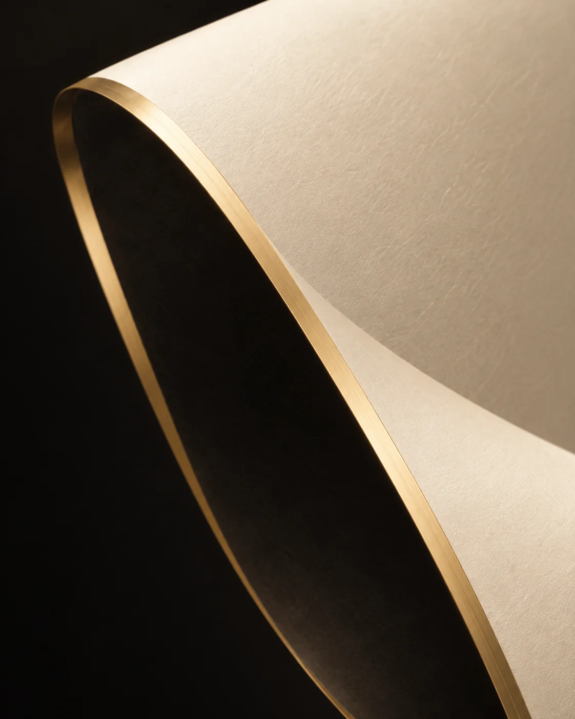 A close view of ivory, black and a fine gold edge.